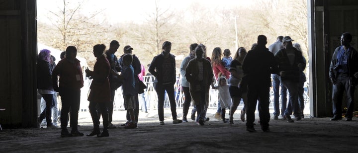 Supporters of U.S. Democratic presidential candidate Senator Bernie Sanders arrive for a campaign event at a livestock barn at the Douglas County Fairgrounds in Lawrence, Kansas March 3, 2016.