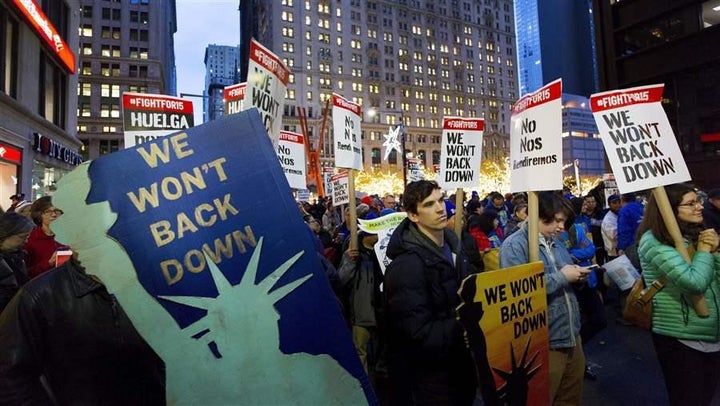 Workers seeking a higher minimum wage demonstrate in New York City in November. As more Americans work nontraditional jobs, demand is growing to restructure employment benefits for them.