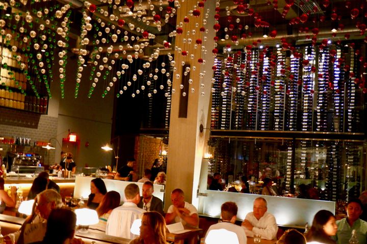 Main dining room has a temperature-controlled glassed off wall of 3,500 wine bottles 