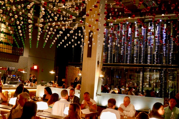 <p>Main dining room has a temperature-controlled glassed off wall of 3,500 wine bottles </p>