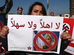 A Lebanese protestor carries a poster saying: “you are not welcome”.