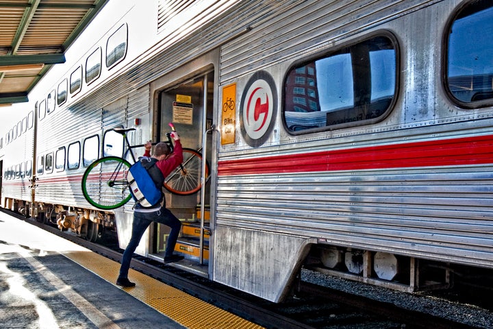 A commuter carries his bicycle aboard a Caltrain train in San Francisco on Nov. 24, 2009. Caltrain and the California High-Speed Rail Authority are facilitating improvements to Caltrain to bring high-speed rail to the region.