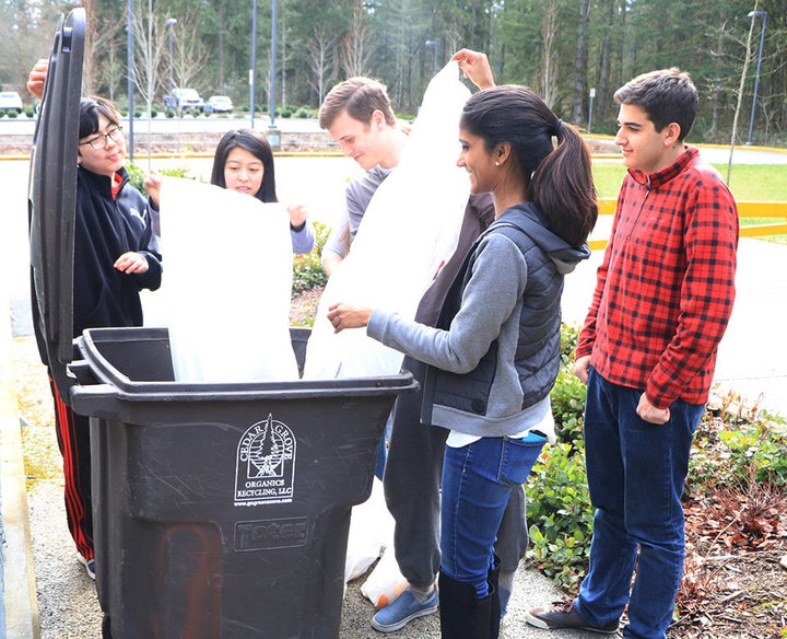 A group of students at Tesla STEM High School records how much waste has been saved through the recycling and composting prog