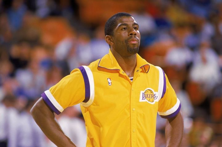 Earvin “Magic” Johnson donning an iconic Lakers warmup.