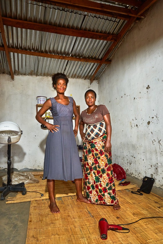 28 year old Esnat (left) and her business partner, Memory (right), stand in their hairdressing salon, Nomec, near Luchenza,