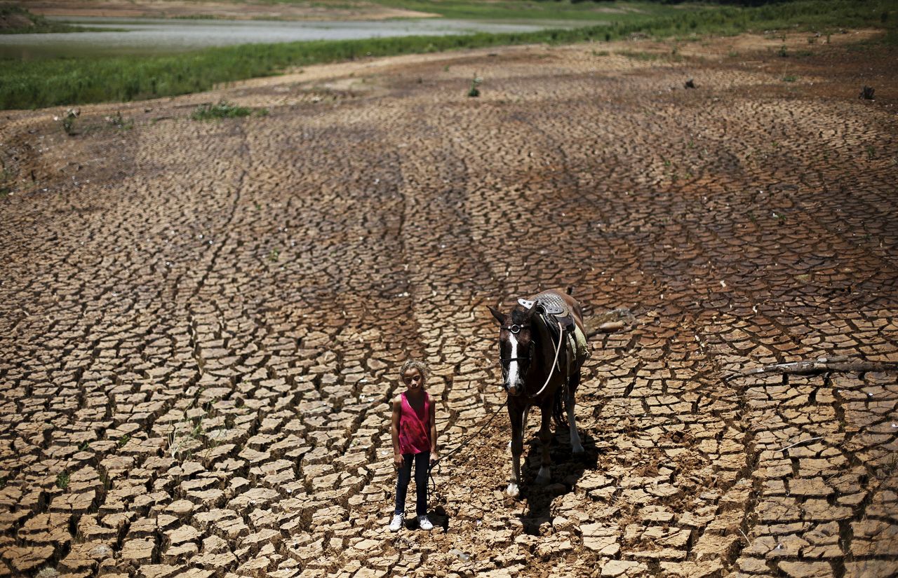 Paula, 7, poses with her horse on the cracked ground of Atibainha dam, part of the Cantareira reservoir, in Nazare Paulista, near Sao Paulo, Brazil, on Feb. 12, 2015.
