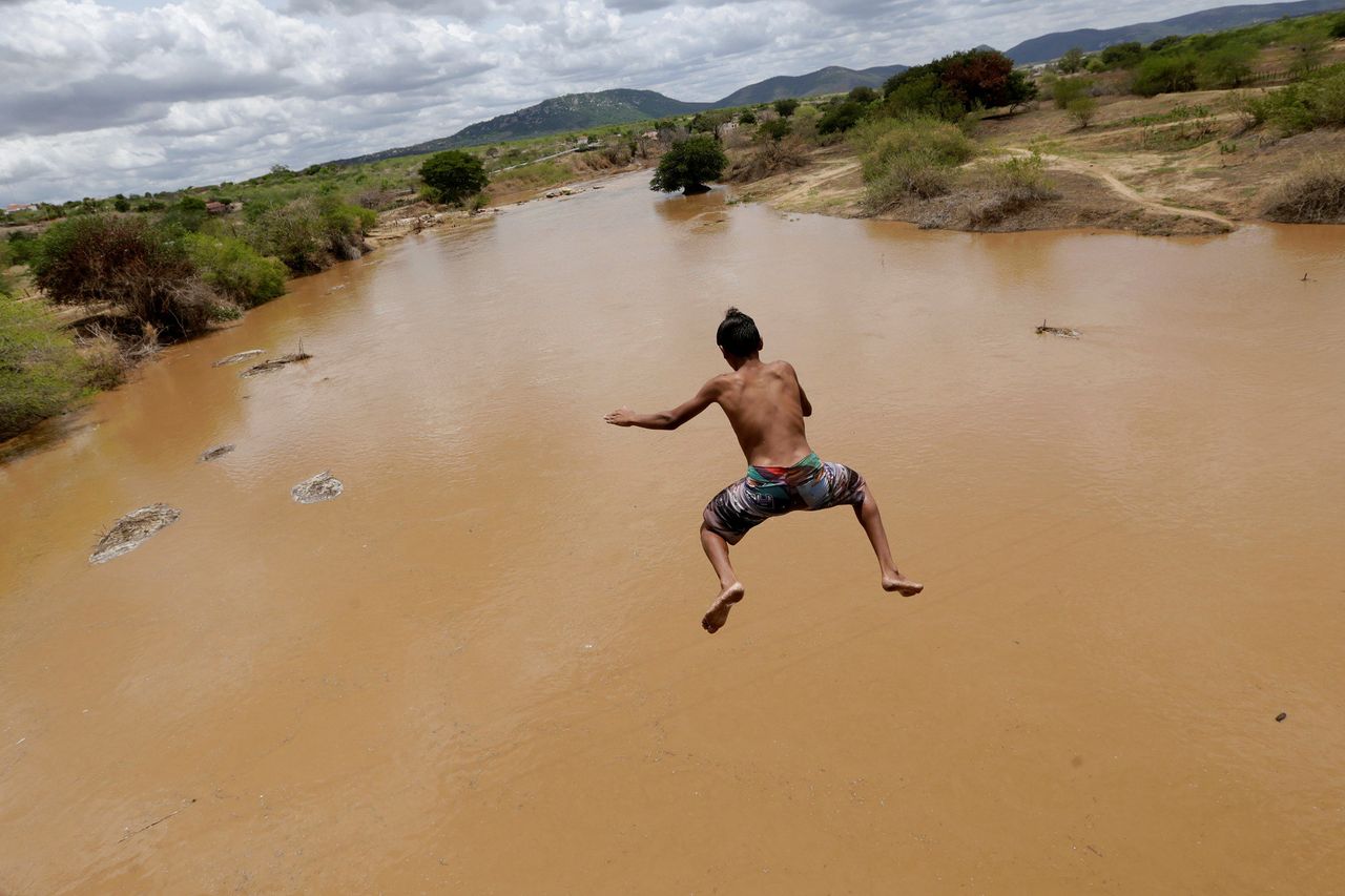 A boy jumps in Pianco River into Pianco, Paraiba state, Brazil, on Feb. 12, 2017.