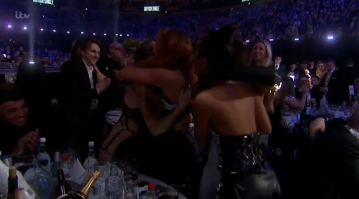 The group threw their arms around one another after discovering they'd won