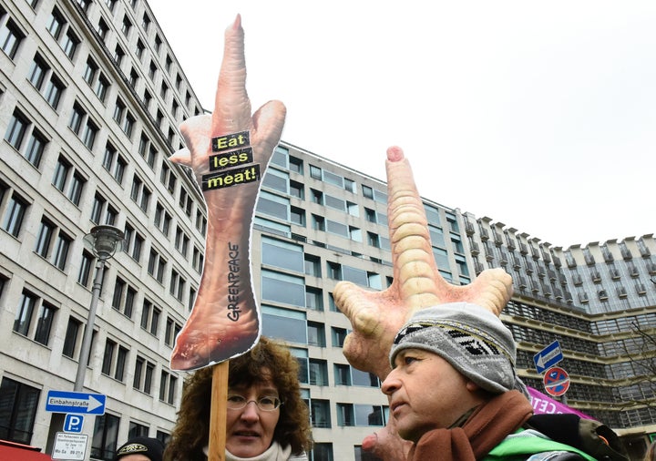 Protesters hold a sign reading "Eat less meat" while taking part in a demonstration during International Green Week in Berlin, Germany, January 16, 2016. Vegetarianism is reportedly on the rise in the country.