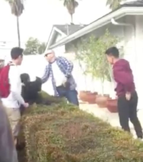 In the video, an off-duty officer pulls a gun from his waistband in front of several minors.