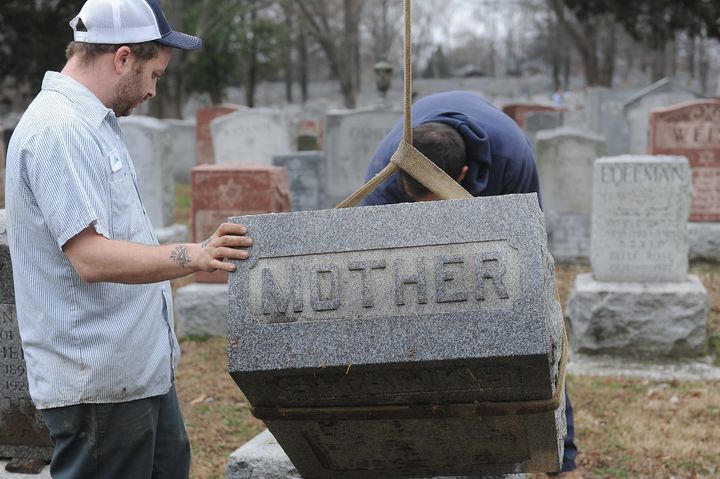 Volunteers from a local monument company help out.