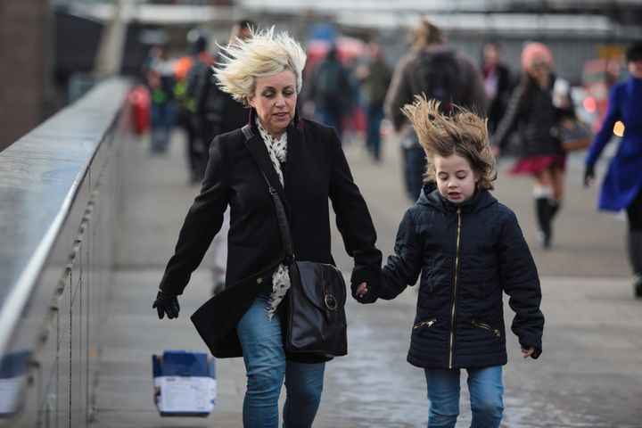 People in London battle against high winds caused by Storm Doris