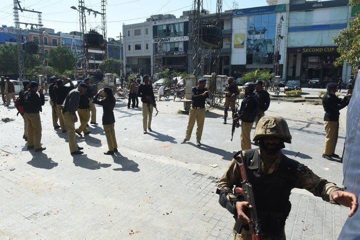 Pakistani soldiers and policemen cordon off the site of a bomb attack in Lahore on February 23, 2017.