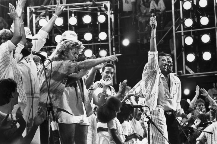 Lionel Richie and Harry Belafonte are joined by other performers at the Live Aid concert in Philadelphia as they all sing the