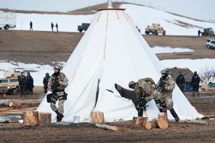 Officers inspect a tepee in while trying to clear Oceti Sakowin camp of several dozen protesters on Thursday.