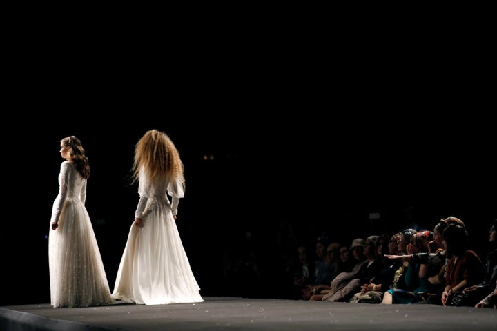 Models stand on the runway during an event dubbed "Modest Fashion Day." 