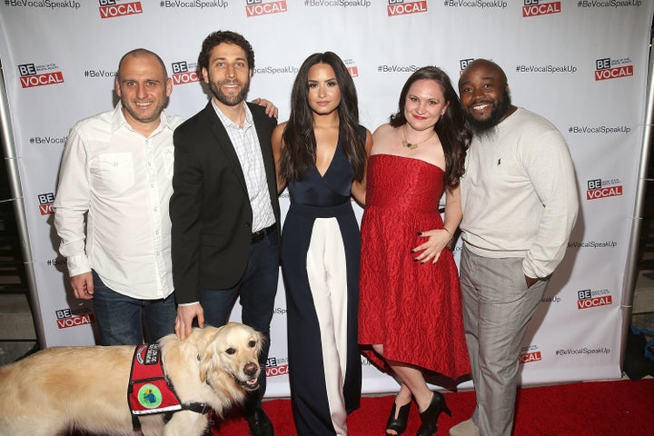 Demi Lovato poses with the cast and crew of "Beyond Silence," a documentary about three people who learned to live well and speak up about mental health.