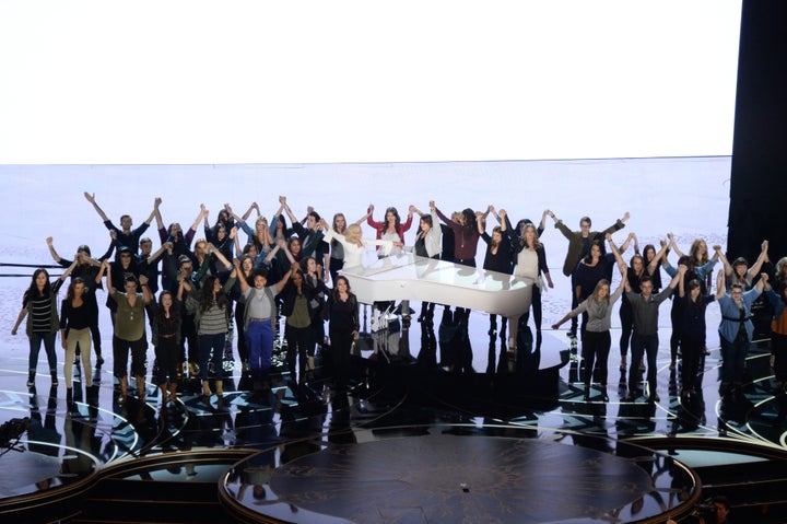 Lady Gaga with sexual assault survivors at the Academy Awards.