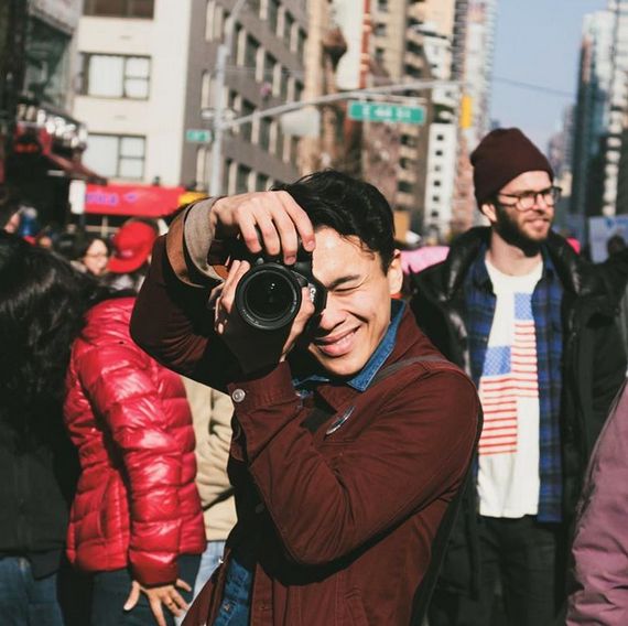 Photographer David Moriya at a protest in January. He always wears a red jacket and pin to protests so people can recognize him. 