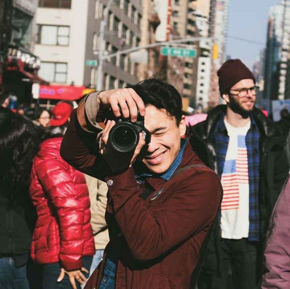Photographer David Moriya at a protest in January. He always wears a red jacket and pin to protests so people can recognize&n