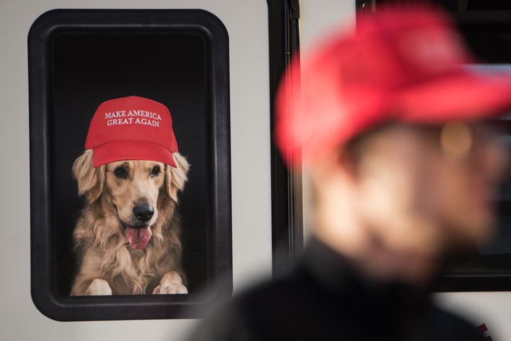 A man stands near a Donald Trump campaign vehicle with an image of a dog in a window before a campaign rally on Feb. 5, 2016, in South Carolina.
