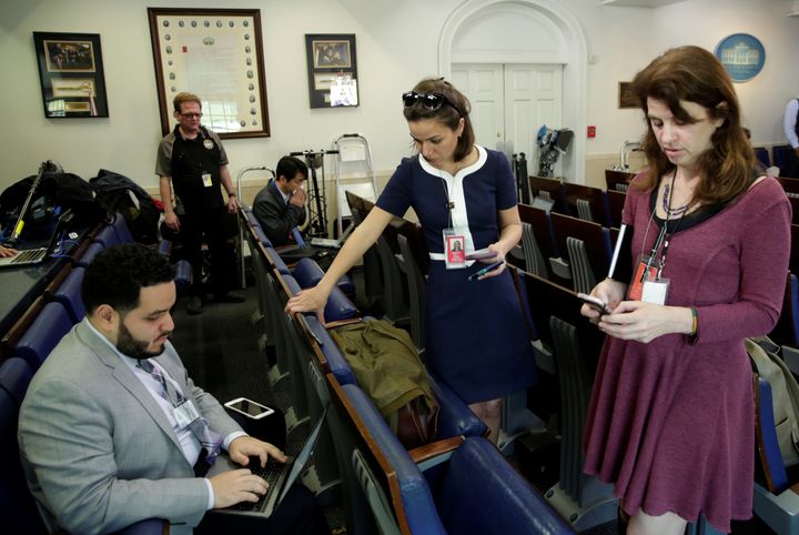 Journalists work in the briefing room at the White House on Friday