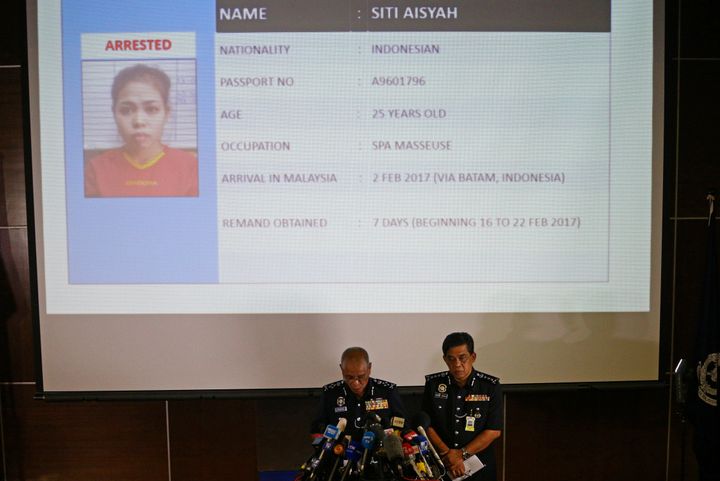 Malaysia's National Police Deputy Inspector-General Noor Rashid Ibrahim (front L) speaks in front of a screen showing detained Indonesian Siti Aisyah