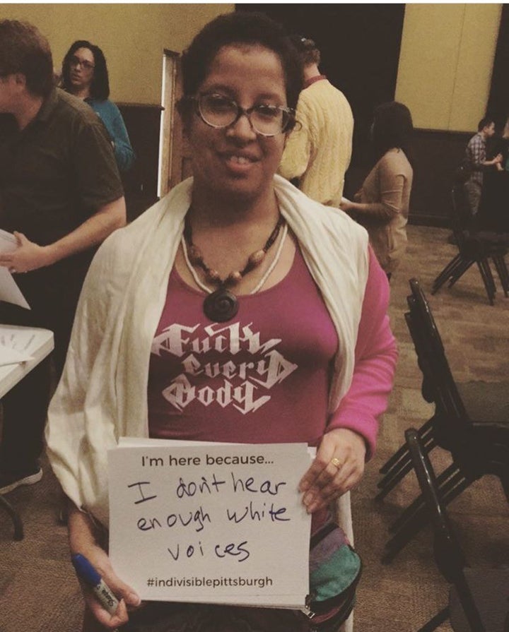 Black Femme Excellence Co. co-founder and feminist activist Sueño Del Mar holds a sign that says “I’m here because I don’t hear enough white voices.” Sueño was approached after the meeting by white Indivisible Pittsburgh leaders who asked her whether she wanted to be involved, not because of her organizing experience, but because of her skin color and the sign she was holding which said “Intersectionality.”