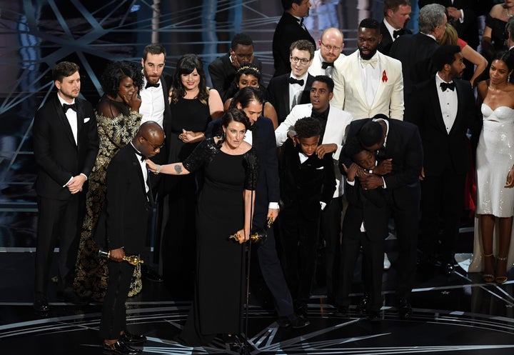 The cast and crew of "Moonlight" accept the Best Picture award onstage Sunday night.