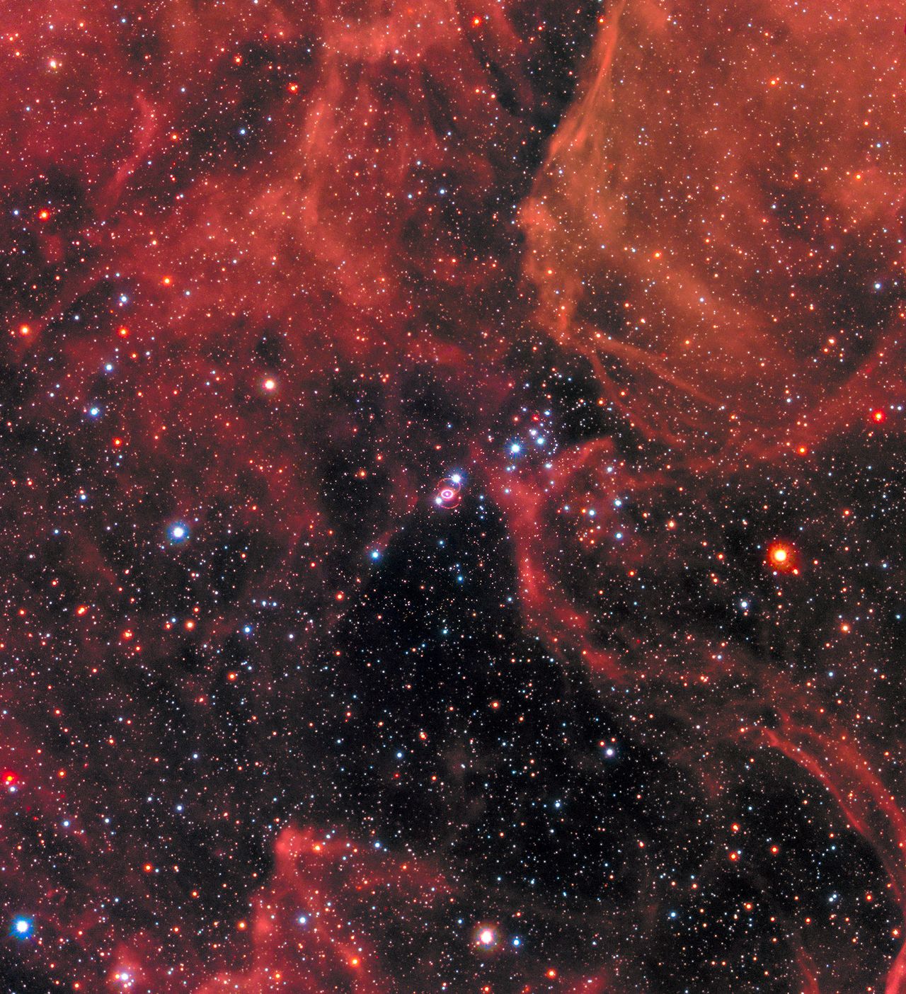 SN 1987A can be seen at the centre of this image, resembling a white eye with a bright white pupil. The image can be viewed in full here.