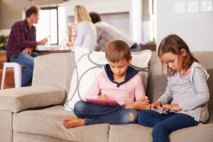 Kids on device while parents chat