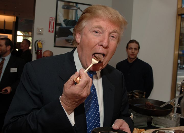 Donald Trump eating a piece of steak.