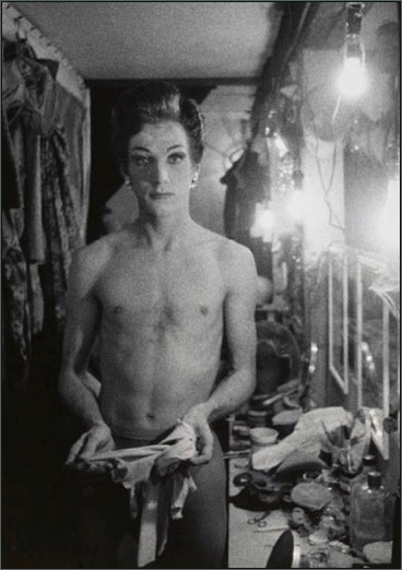 Female impersonator holding long gloves, Hempstead, L.I. 1959
