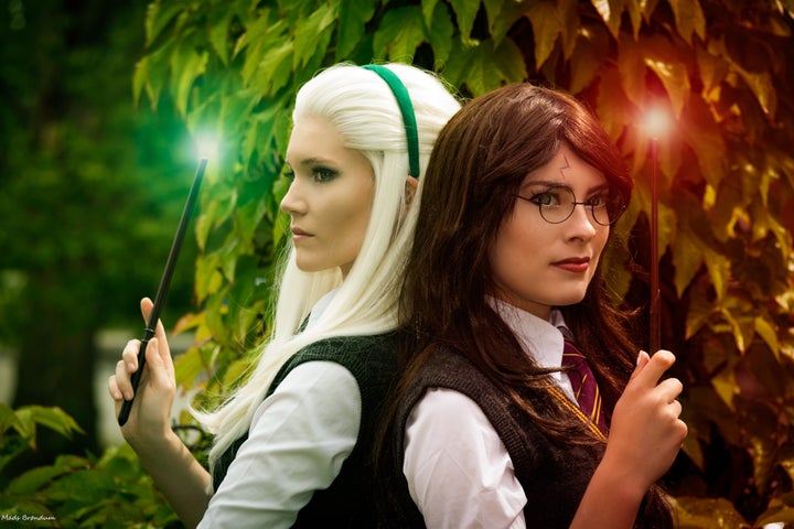 Sørine (aka Surine Cosplay) as a female Draco Malfoy on the left and Carina (aka Rinaca Cosplay) as a female Harry Potter on the right.