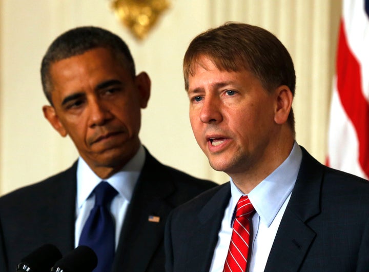 U.S. President Barack Obama (L) looks at the new Director of the Consumer Financial Protection Bureau Richard Cordray in the State Dining Room at the White House in Washington July 17, 2013.