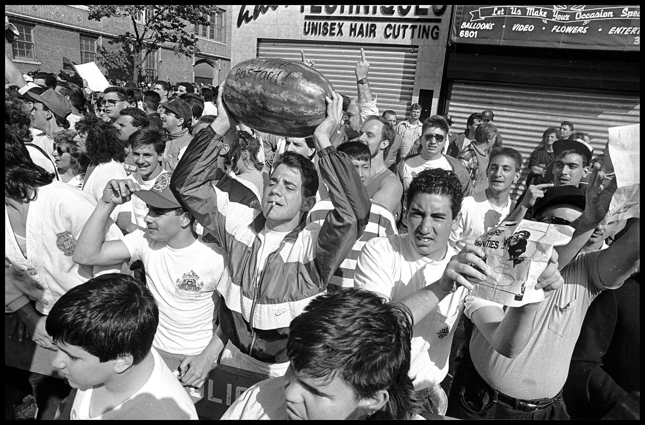 Bensonhurst residents hold up watermelons to mock African American protestors who took to the streets of the largely Italian neighborhood in Brooklyn following the acquittal of Bensonhurst resident Keith Mondello in the shooting death of 16-year-old African American Yusef Hawkins on May 19, 1990. Hawkins, who had gone to the neighborhood to look at a used car, was met by a white mob and shot to death. (Ricky Flores, Canarsie, Brooklyn, 1990.)