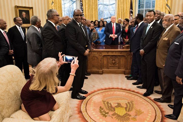 This photograph clearly shows Conway capturing her own momento of the occasion - and doing so while kneeling on the Oval Office sofa. It's possible she was on the sofa so as not to obstruct the view of White House photographers