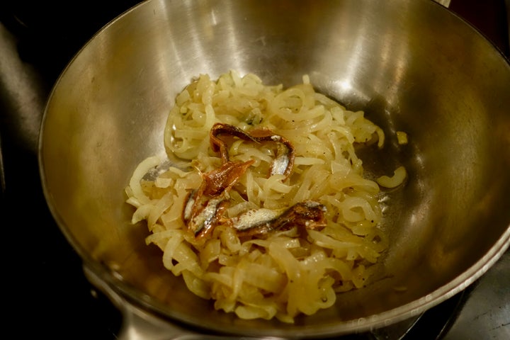 <p>Anchovies added to onions</p>