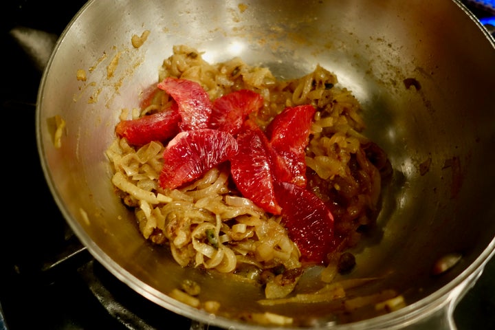 The orange segments and juice lighten and brighten the savory onion mixture