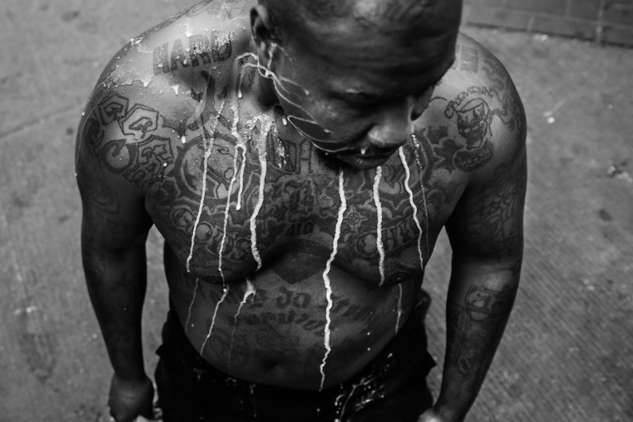 A mixture of milk and water rolls down a man's chest after he was pepper sprayed by the Baltimore Police during violent protests following Freddie Gray's funeral in 2015.