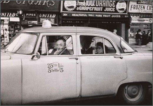 Taxicab driver at the wheel with two passengers, N.Y.C., 1956.