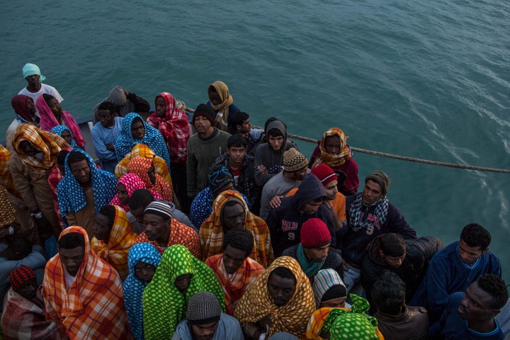 Migrants and refugees wait to disembark after being rescued off the Libyan coast on Feb 19, 2017. 