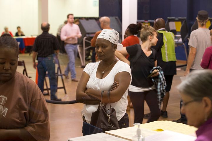 A woman waits to vote after having an ID check in Austin, Texas.