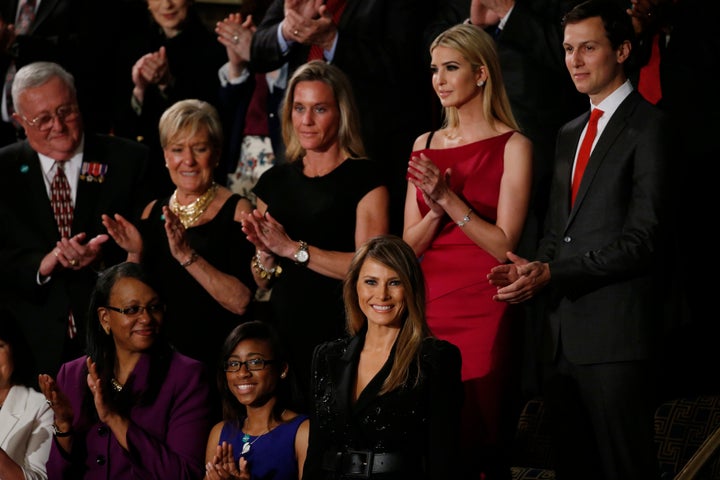 First lady Melania Trump, bottom center, is applauded as her husband begins his speech. Behind her is Trump's daughter Ivanka, who is credited with promoting family leave and child care help.