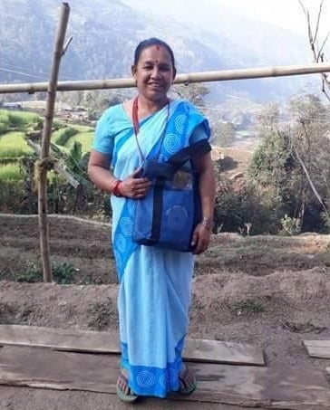 Ganga Acharya, wearing the blue sari worn by FCHVs so they are known to the community.