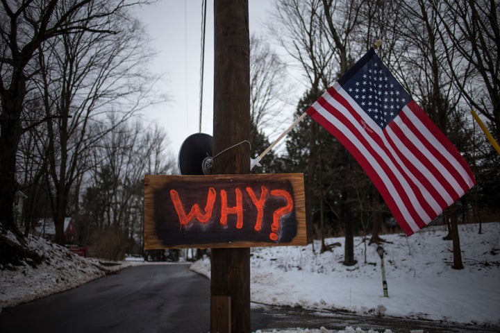 A sign is posted on an electricity pole outside a house near Sandy Hook Elementary School, nearly two weeks after a gunman shot dead 20 students and six adults, in Newtown, Connecticut, on Dec. 27, 2012. 