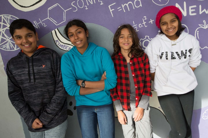 BASIS Independent School of Silicon Valley students stand in front of a science-themed mural designed by high school student Kimberly Hou. The school is one of hundreds around the world participating in an international test of 15-year-olds in math, science and reading.