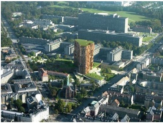 Modern buildings, some with green roofs, abutting neighborhood amenities. 