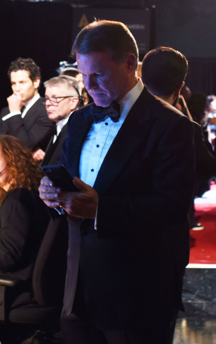 Brian Cullinan using his phone backstage at 9:04pm PST at the 89th annual Academy Awards.
