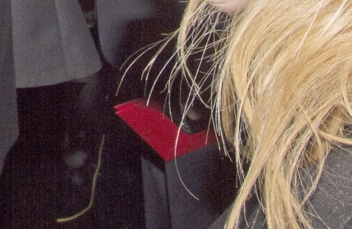 Detail of award envelopes and phone in Brian Cullinan's hand backstage during the 89th annual Academy Awards.